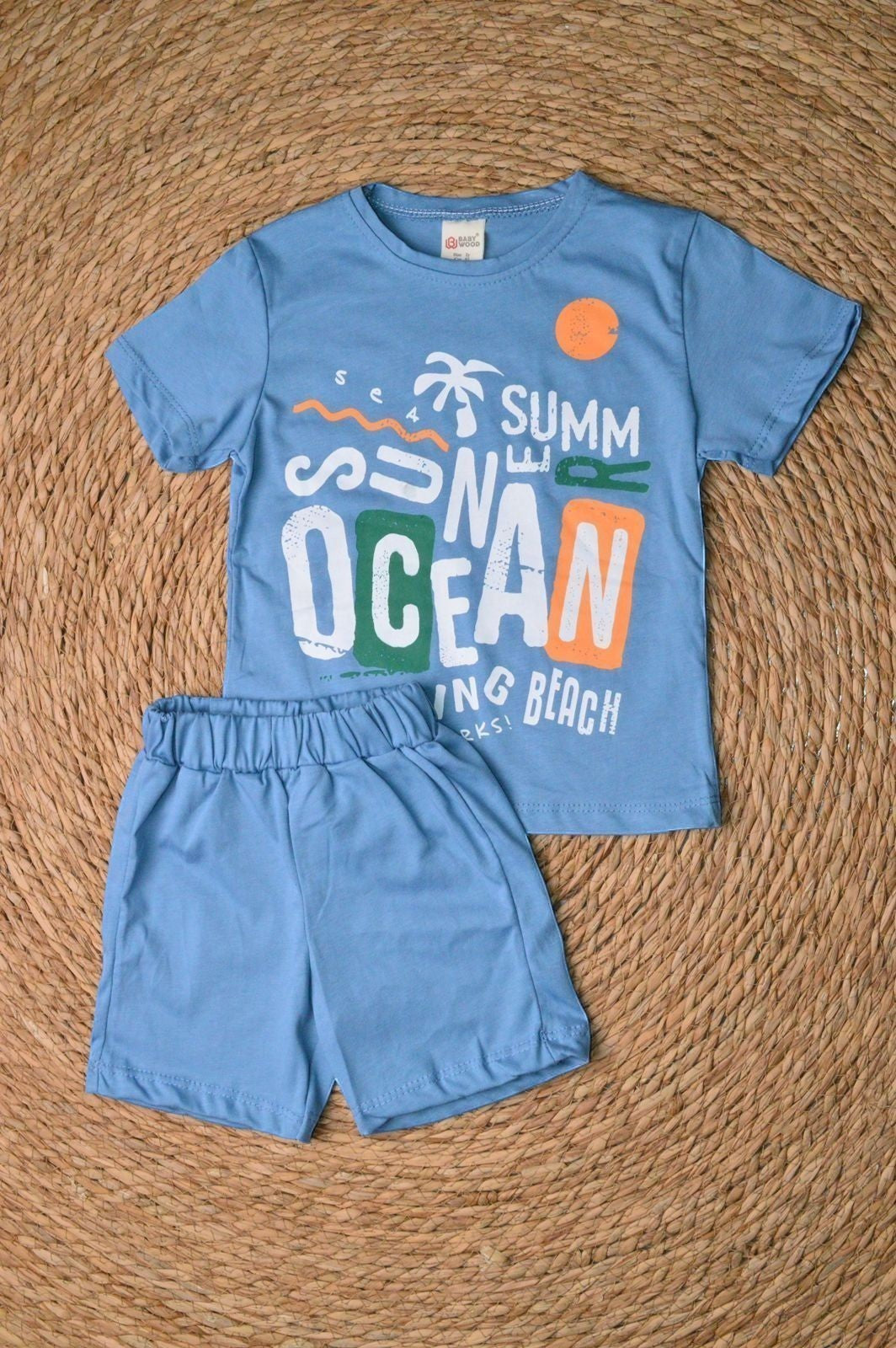 L'armoire De Yasmina blue cotton t-shirt and shorts set with "Summer Ocean" graphic print