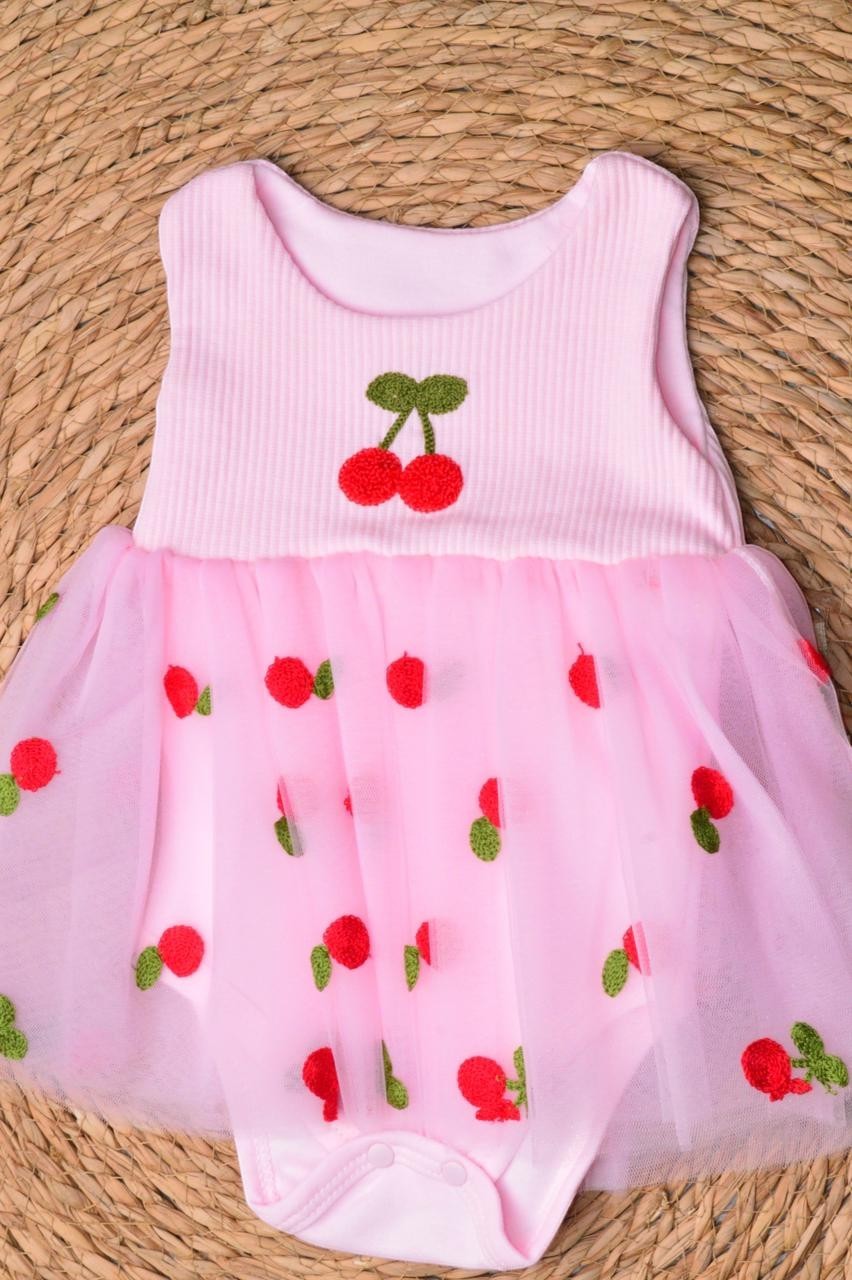 L'armoire De Yasmina pink ribbed knit romper with tulle overlay adorned with embroidered cherries.